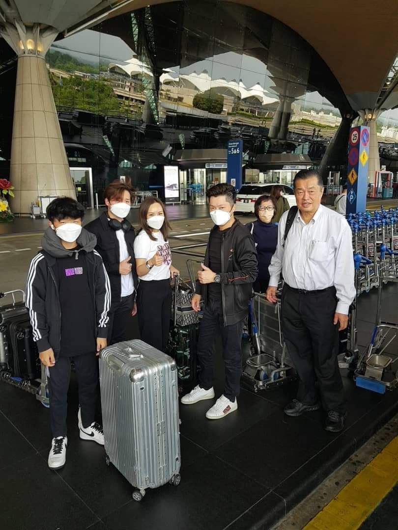 A group of travellers with luggage at the airport