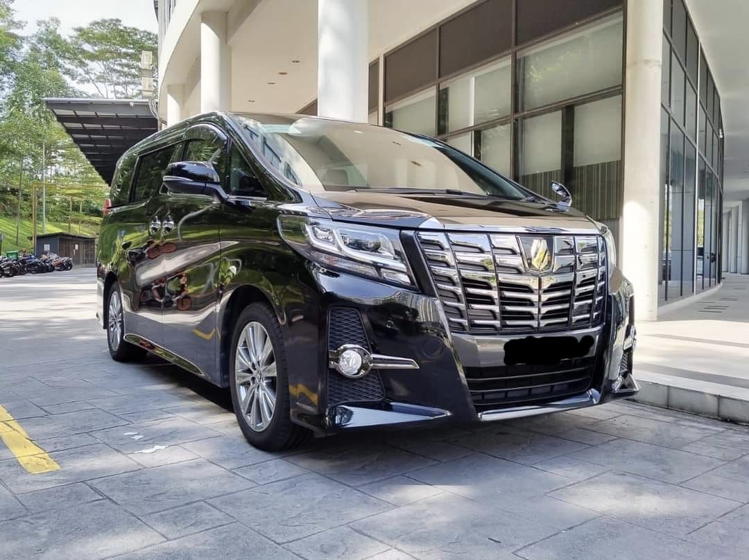 Black Toyota Alphard parked outside a building